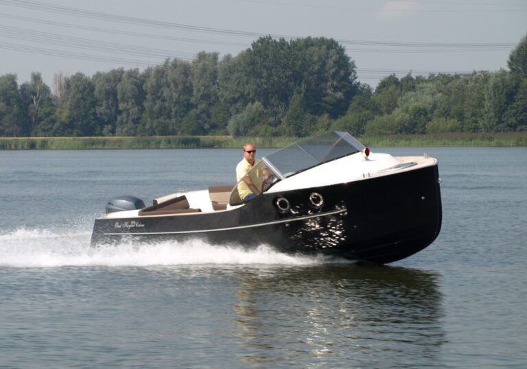 Oud Huijzer 700 Cabin varend met zwarte romp en klassieke boeg.
